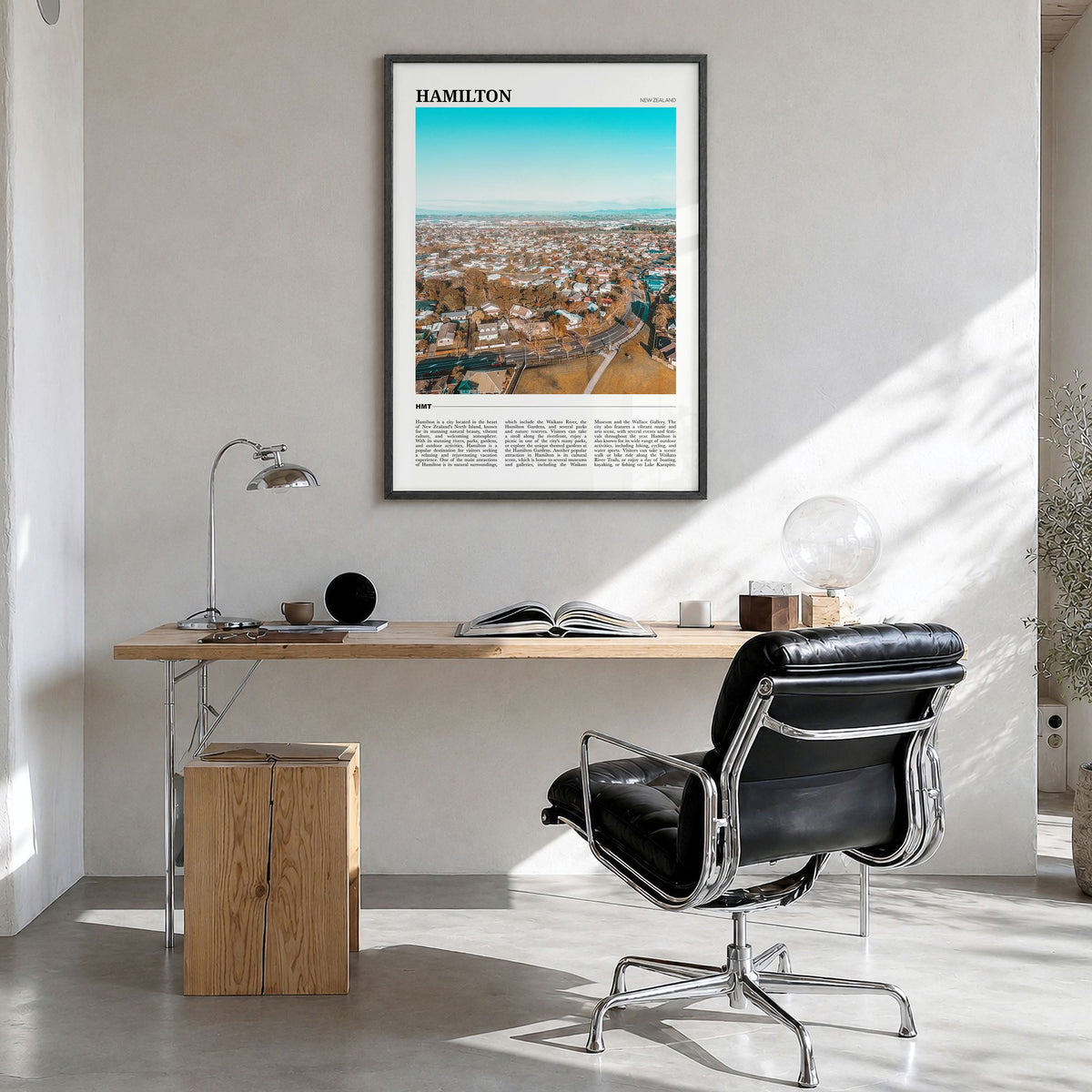 Hamilton, New Zealand Travel Poster in a black wood frame, hanging in a bright home office