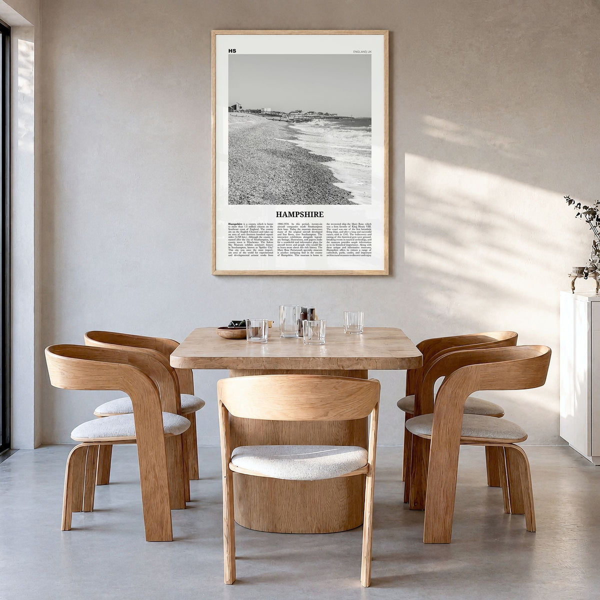 Hampshire Newspaper Poster in a natural wood frame, hanging in a dining room