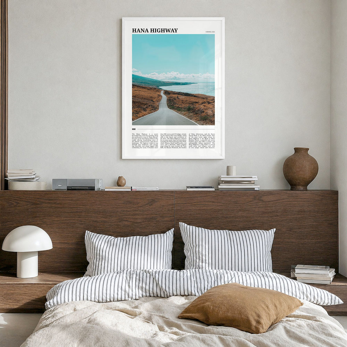 Hana Highway Travel Poster in a white wood frame, hanging in a bedroom