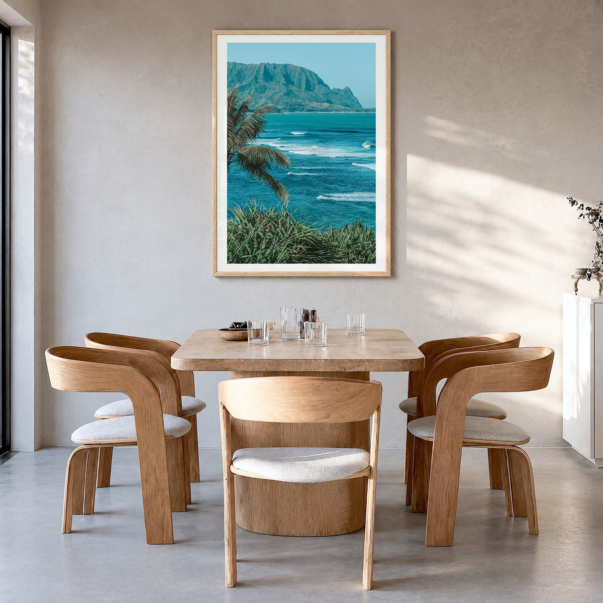 Hanalei Photo Poster in a natural wood frame, hanging in a dining room, white border