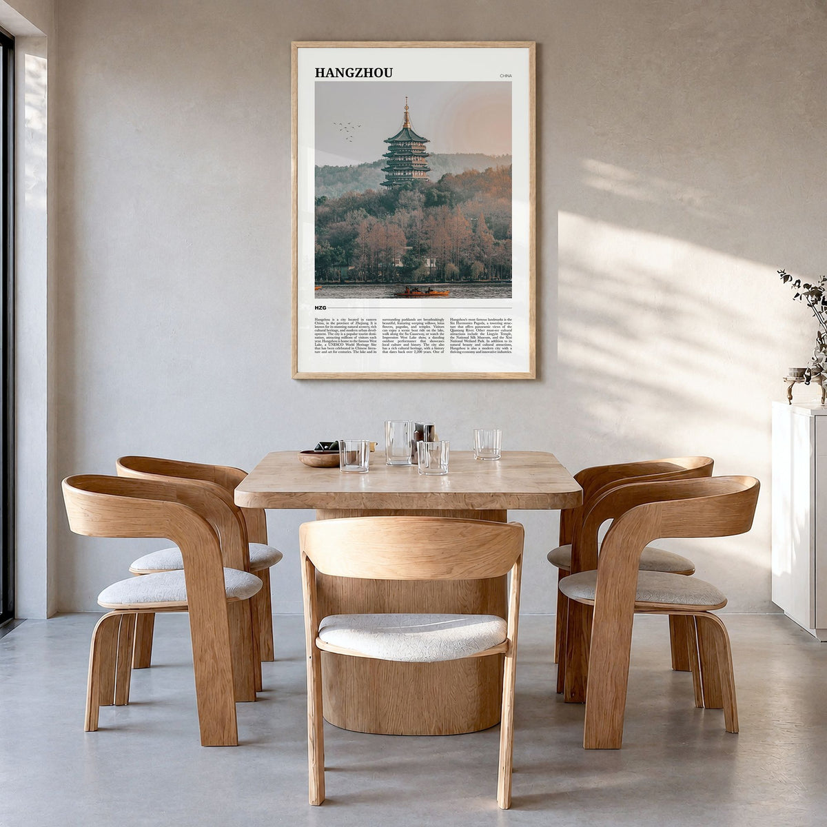 Hangzhou Travel Poster in a natural wood frame, hanging in a dining room