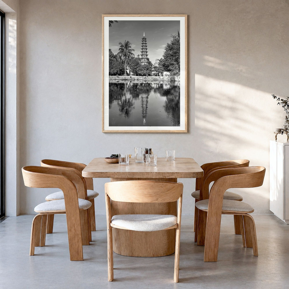 Hanoi Photo Poster in a natural wood frame, hanging in a dining room, white border