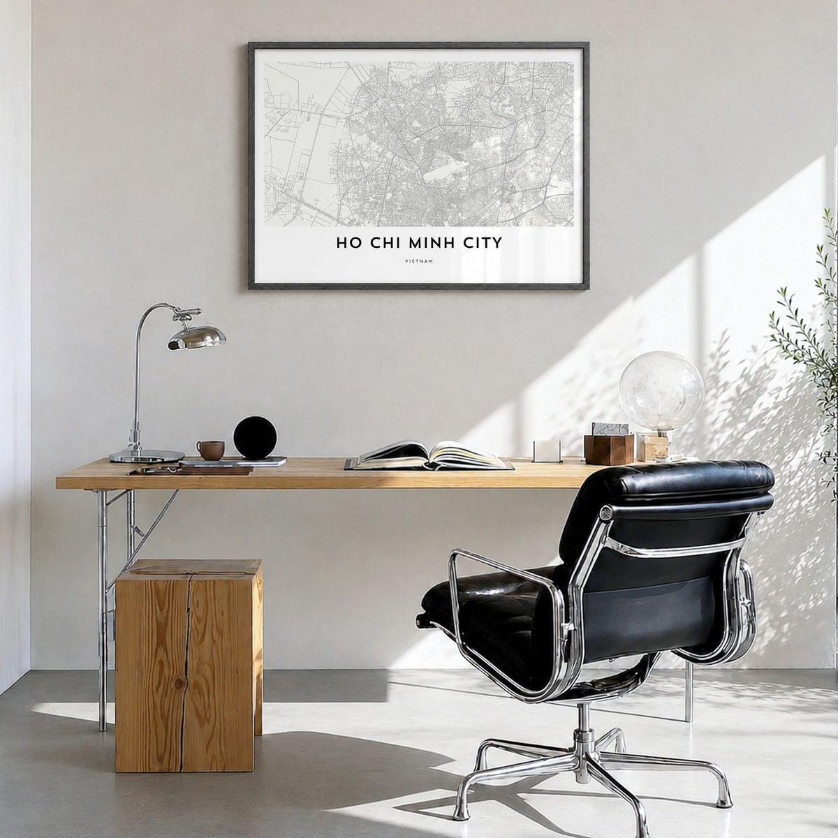 Ho Chi Minh City Map Poster in a black wood frame, hanging in a bright home office