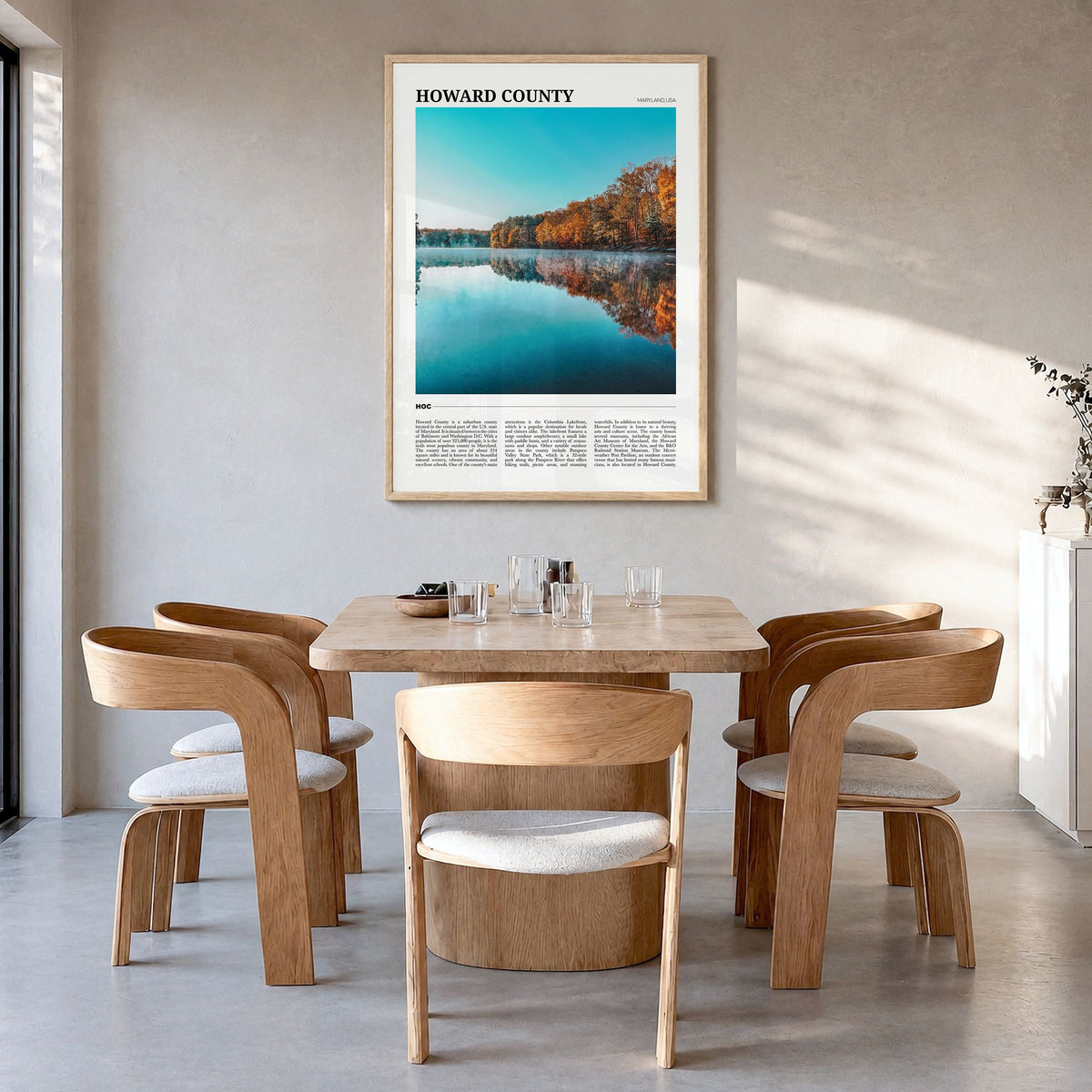 Howard County Travel Poster in a natural wood frame, hanging in a dining room