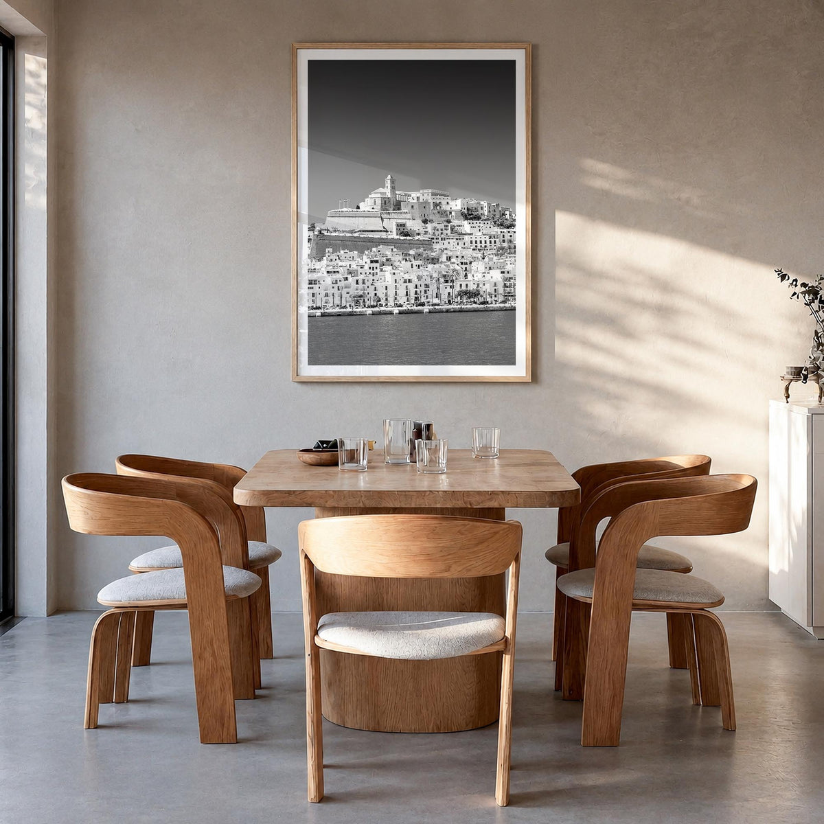 Ibiza black & white photo poster of Spain – vertical wall art in natural wood frame with white border, hanging on wall
