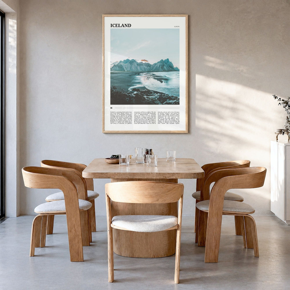 Iceland Travel Poster in a natural wood frame, hanging in a dining room