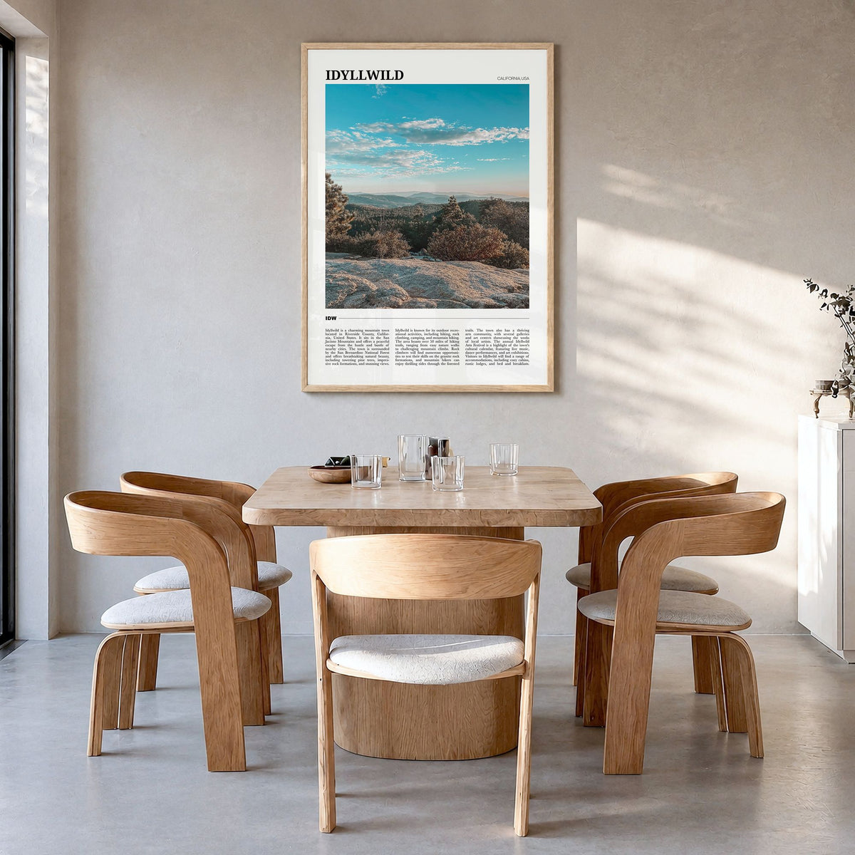 Idyllwild Travel Poster in a natural wood frame, hanging in a dining room