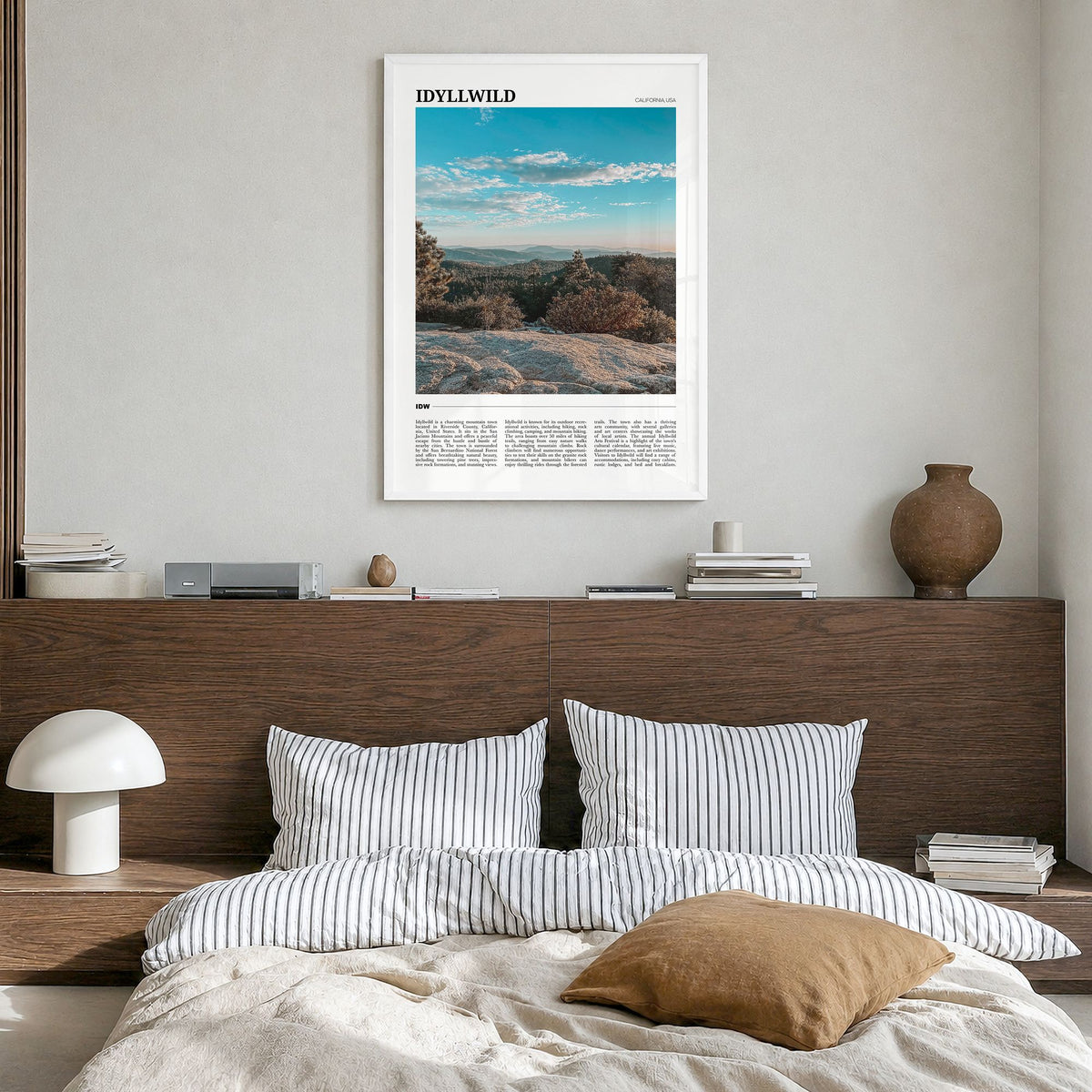 Idyllwild Travel Poster in a white wood frame, hanging in a bedroom