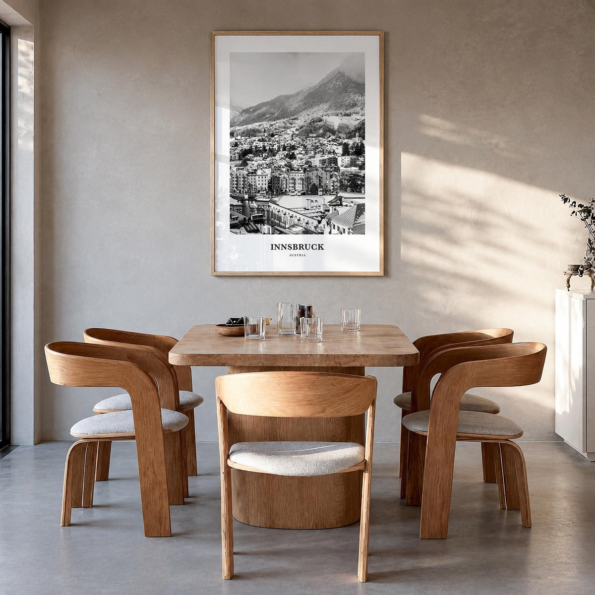 Innsbruck black & white classic poster of Austria – vertical wall art in natural wood frame, hanging on wall