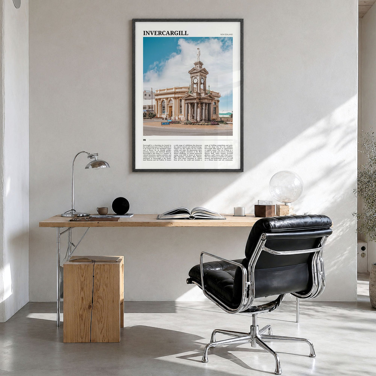 Invercargill Travel Poster in a black wood frame, hanging in a bright home office