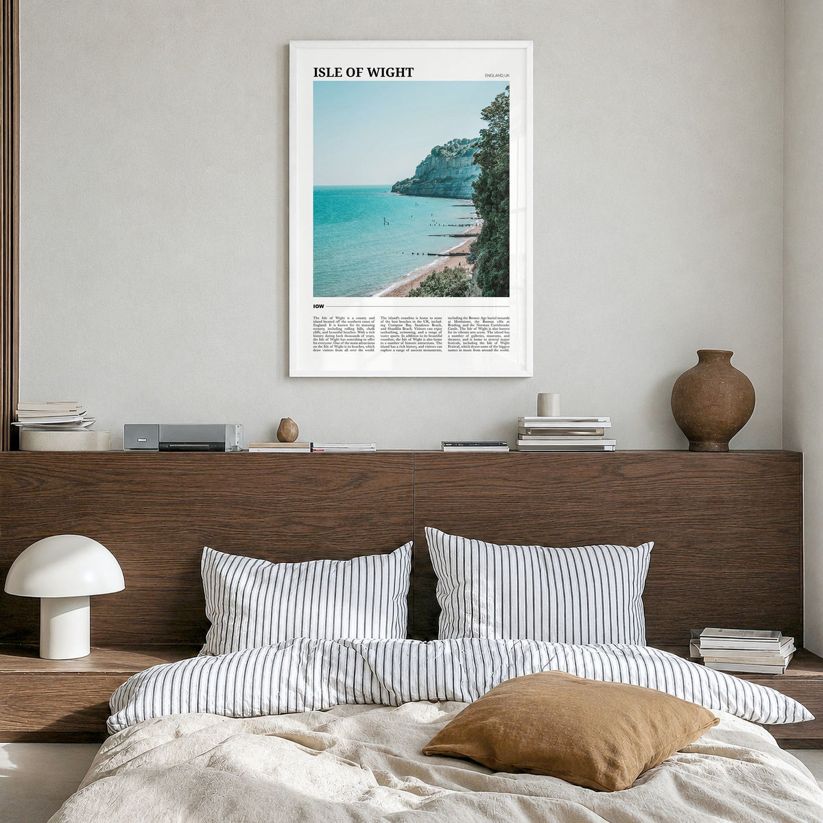 Isle of Wight Travel Poster in a white wood frame, hanging in a bedroom