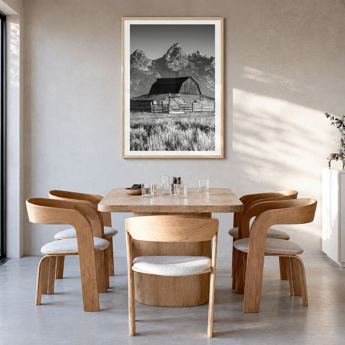 Jackson Hole Photo Poster in a natural wood frame, hanging in a dining room, white border