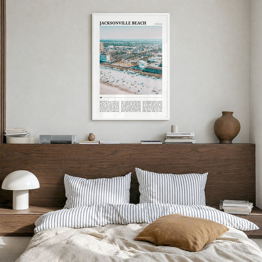 Jacksonville Beach Travel Poster in a white wood frame, hanging in a bedroom