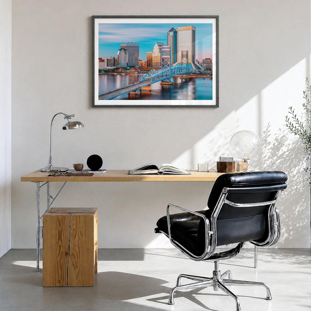 Jacksonville Photo Poster in a black wood frame, hanging in a bright home office, white border