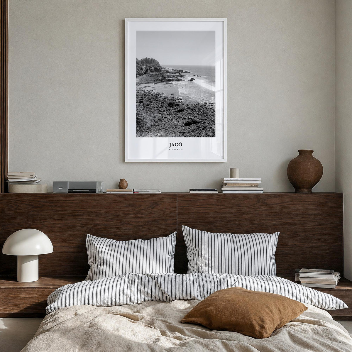 Jacó black & white classic poster of Costa Rica – vertical wall art in white wood frame, hanging on wall