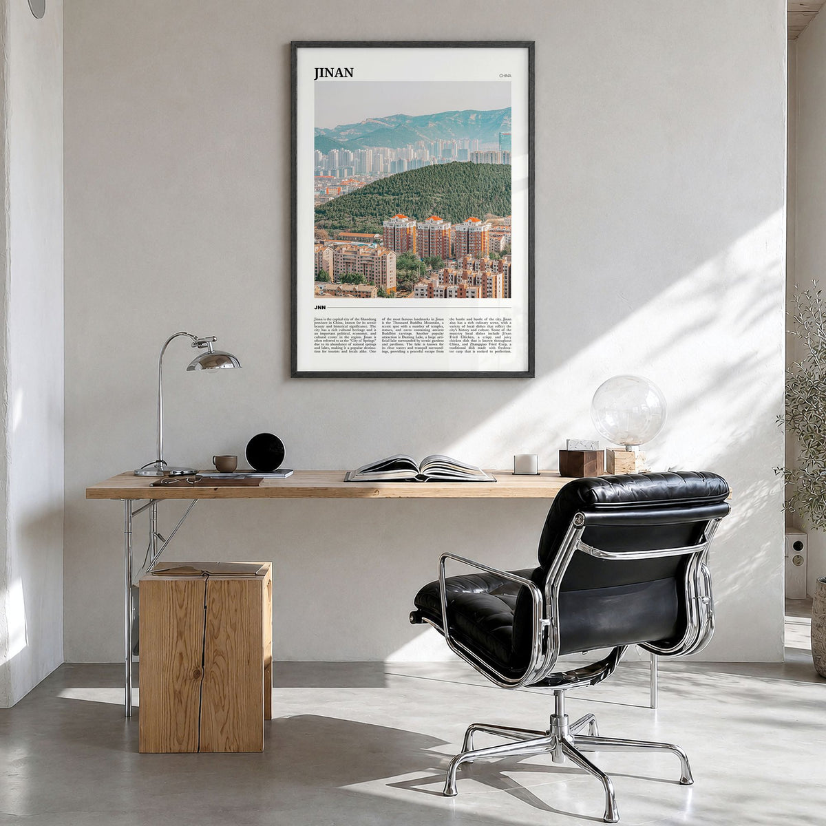 Jinan Travel Poster in a black wood frame, hanging in a bright home office