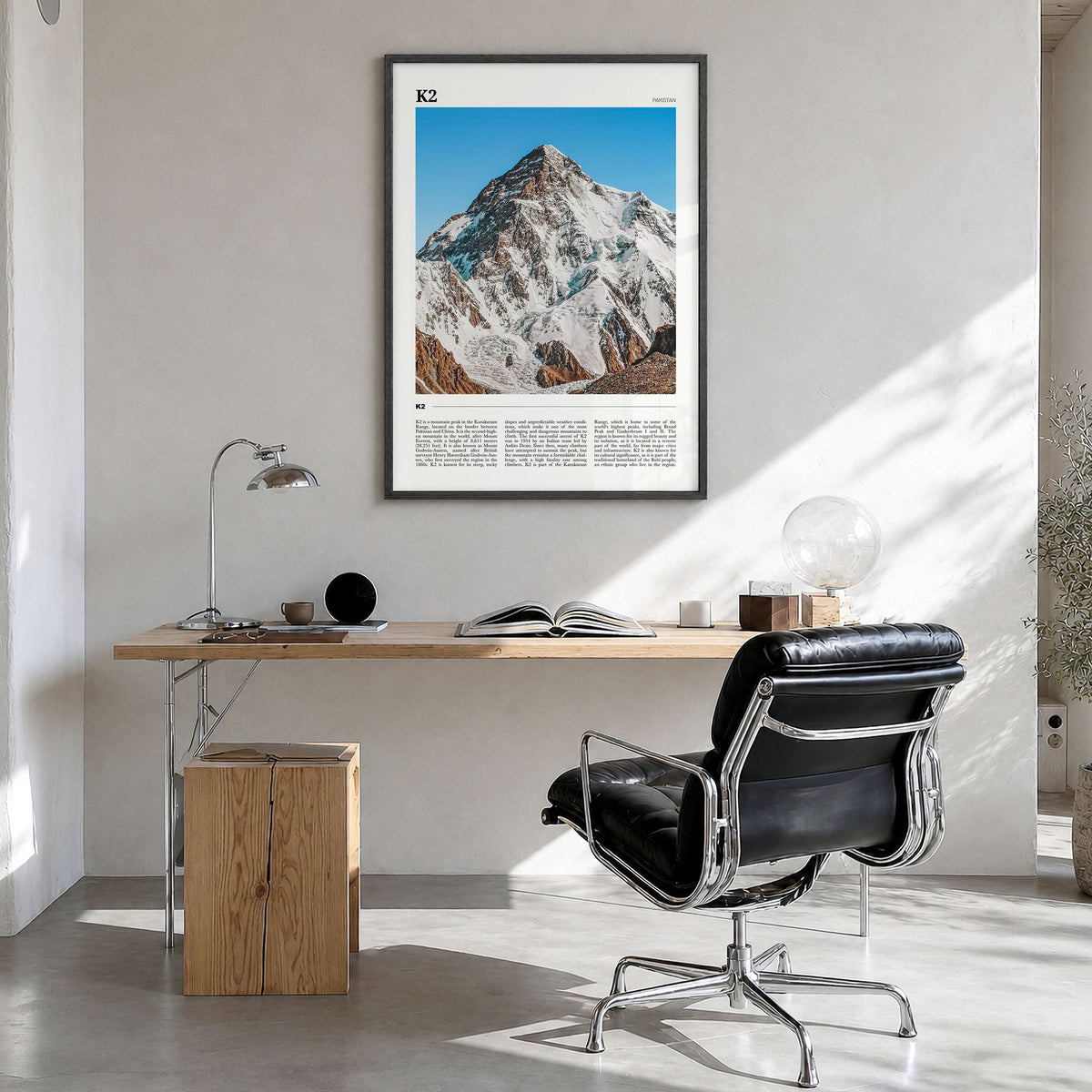 K2 Travel Poster in a black wood frame, hanging in a bright home office