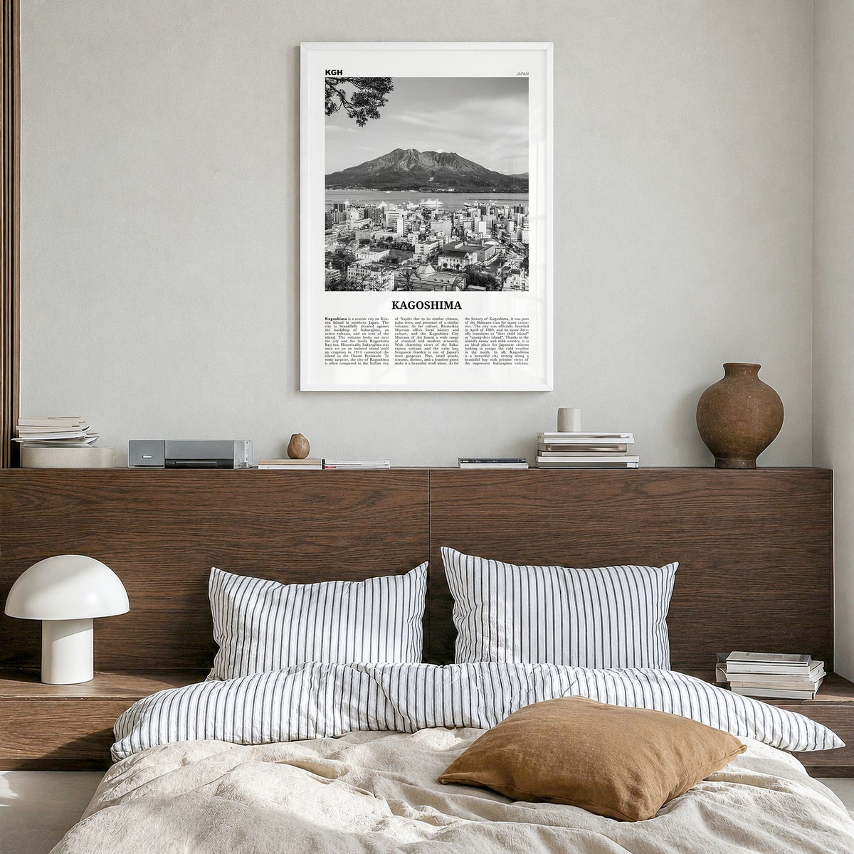 Kagoshima Newspaper Poster in a white wood frame, hanging in a bedroom