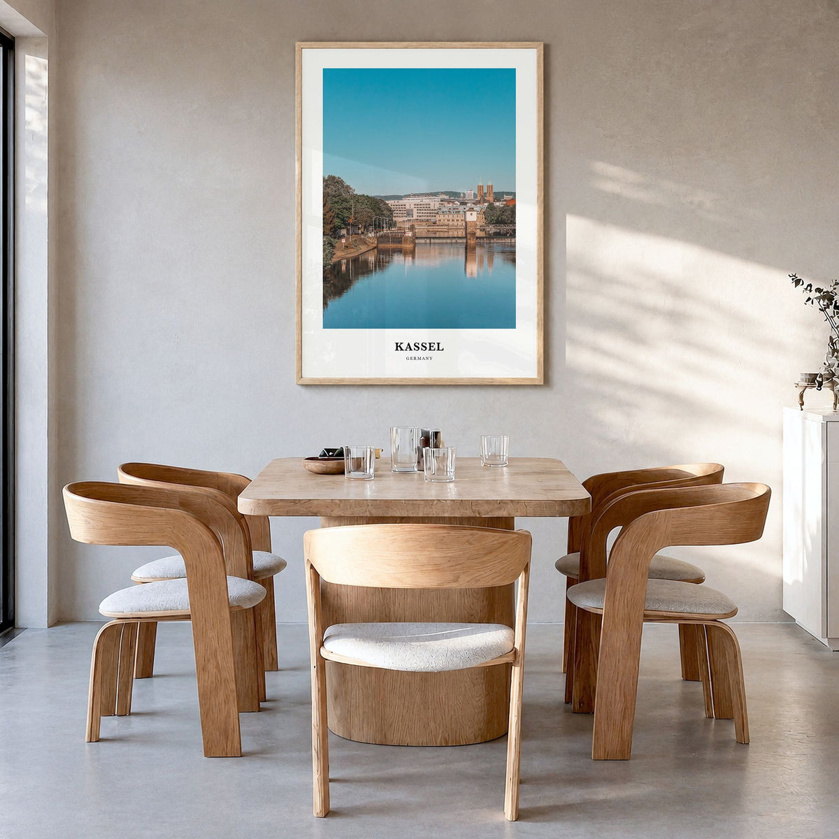 Kassel Classic Poster in a natural wood frame, hanging in a dining room