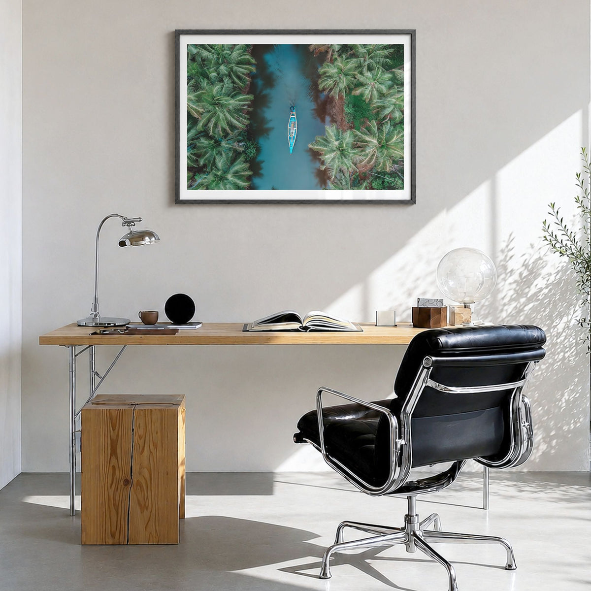 Kerala Photo Poster in a black wood frame, hanging in a bright home office, white border