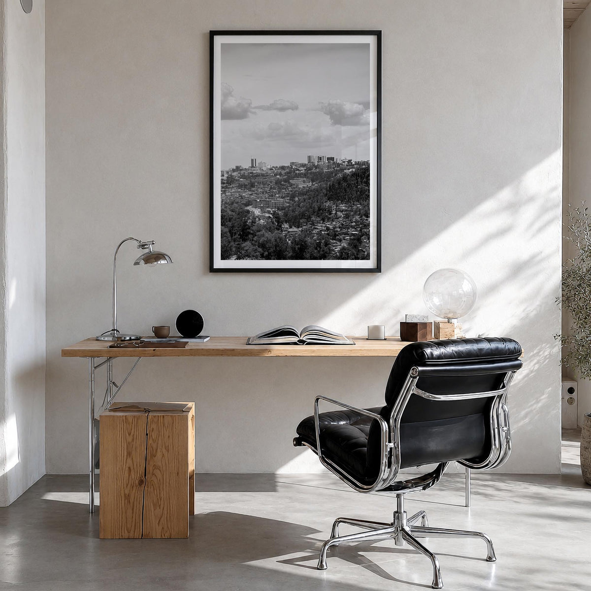 Kigali black & white photo poster of Rwanda – vertical wall art in black wood frame with white border, hanging on wall