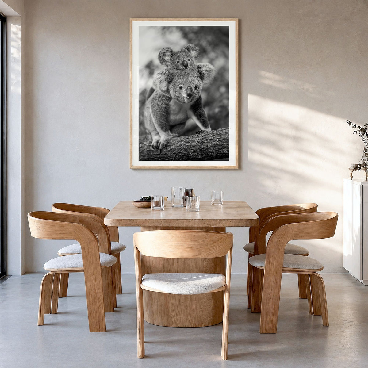 Koala Photo No 2 Poster in a natural wood frame, hanging in a dining room, white border