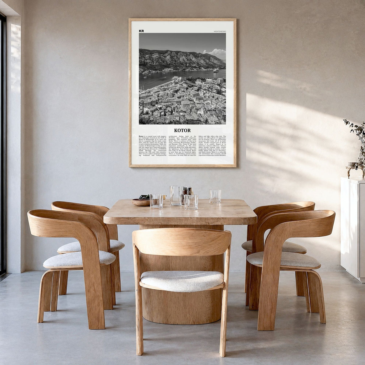 Kotor Newspaper Poster in a natural wood frame, hanging in a dining room