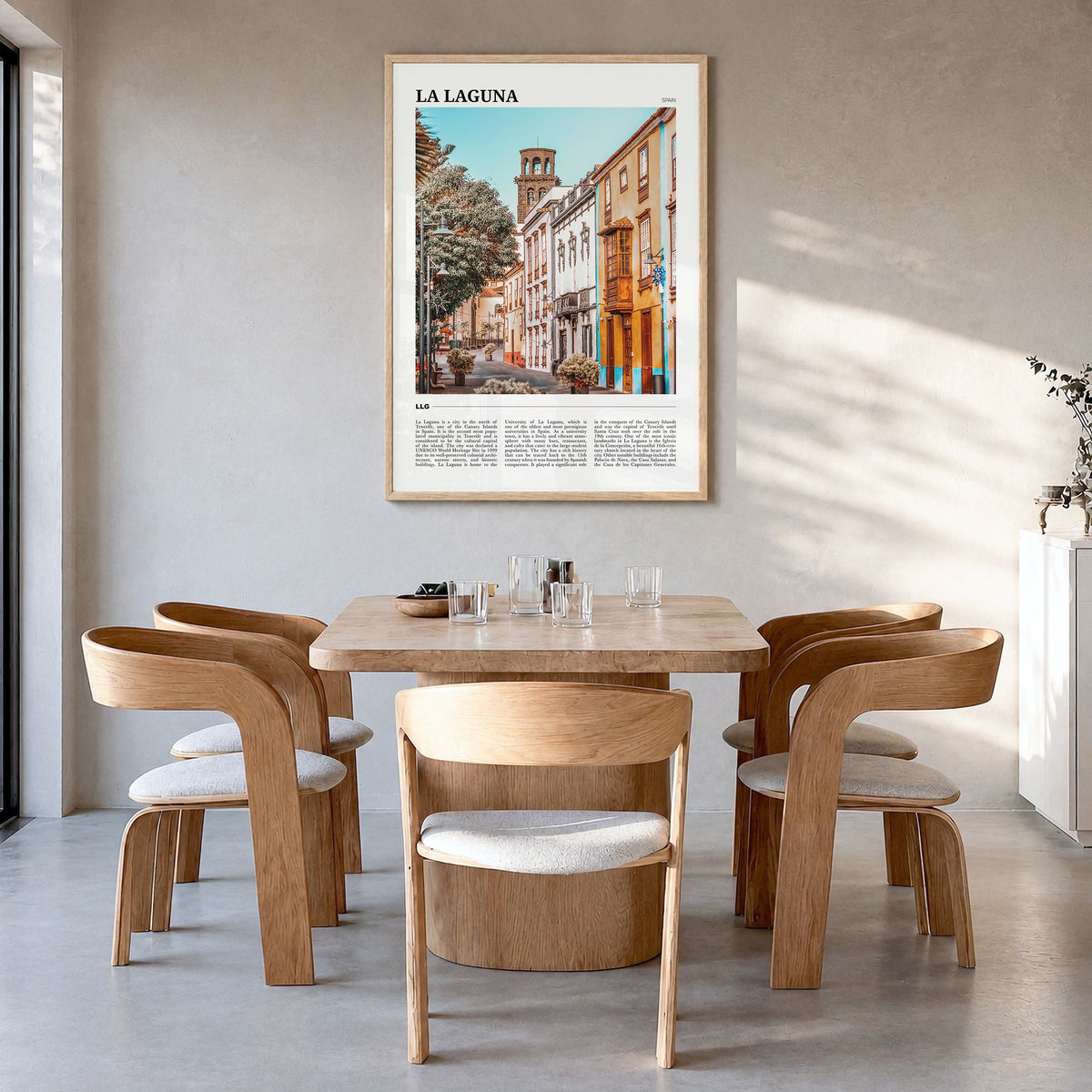 La Laguna Travel Poster in a natural wood frame, hanging in a dining room