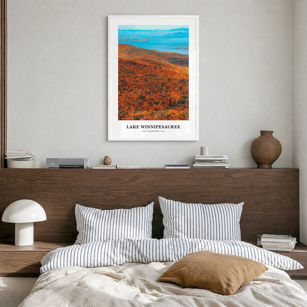 Lake Winnipesaukee Classic Poster in a white wood frame, hanging in a bedroom