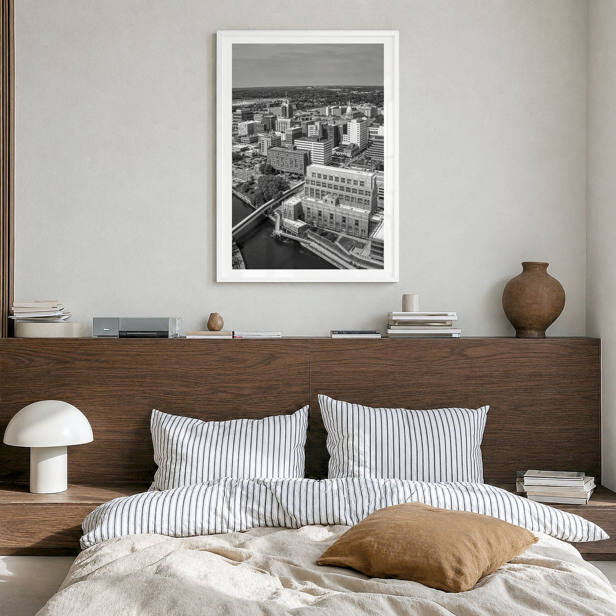 Lansing Photo Poster in a white wood frame, hanging in a bedroom, white border