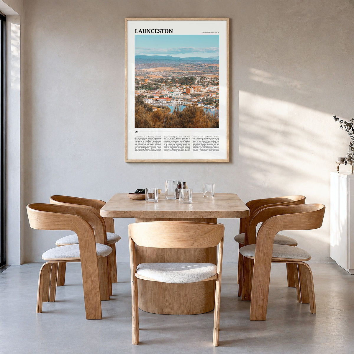 Launceston Travel Poster in a natural wood frame, hanging in a dining room