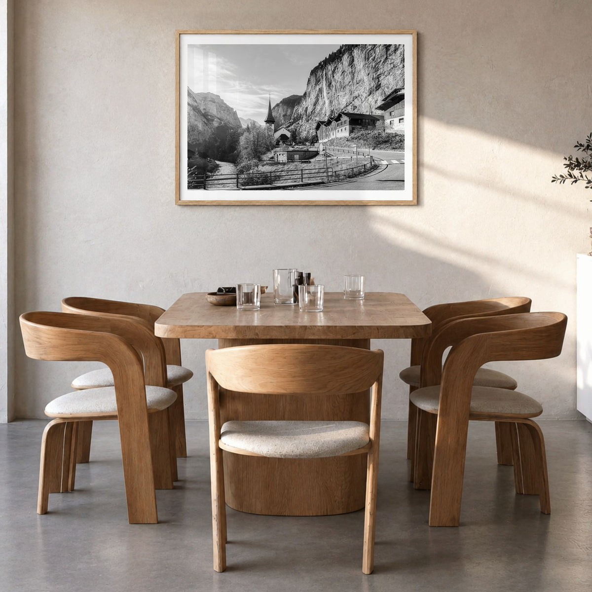 Lauterbrunnen Photo Poster in a natural wood frame, hanging in a dining room, white border