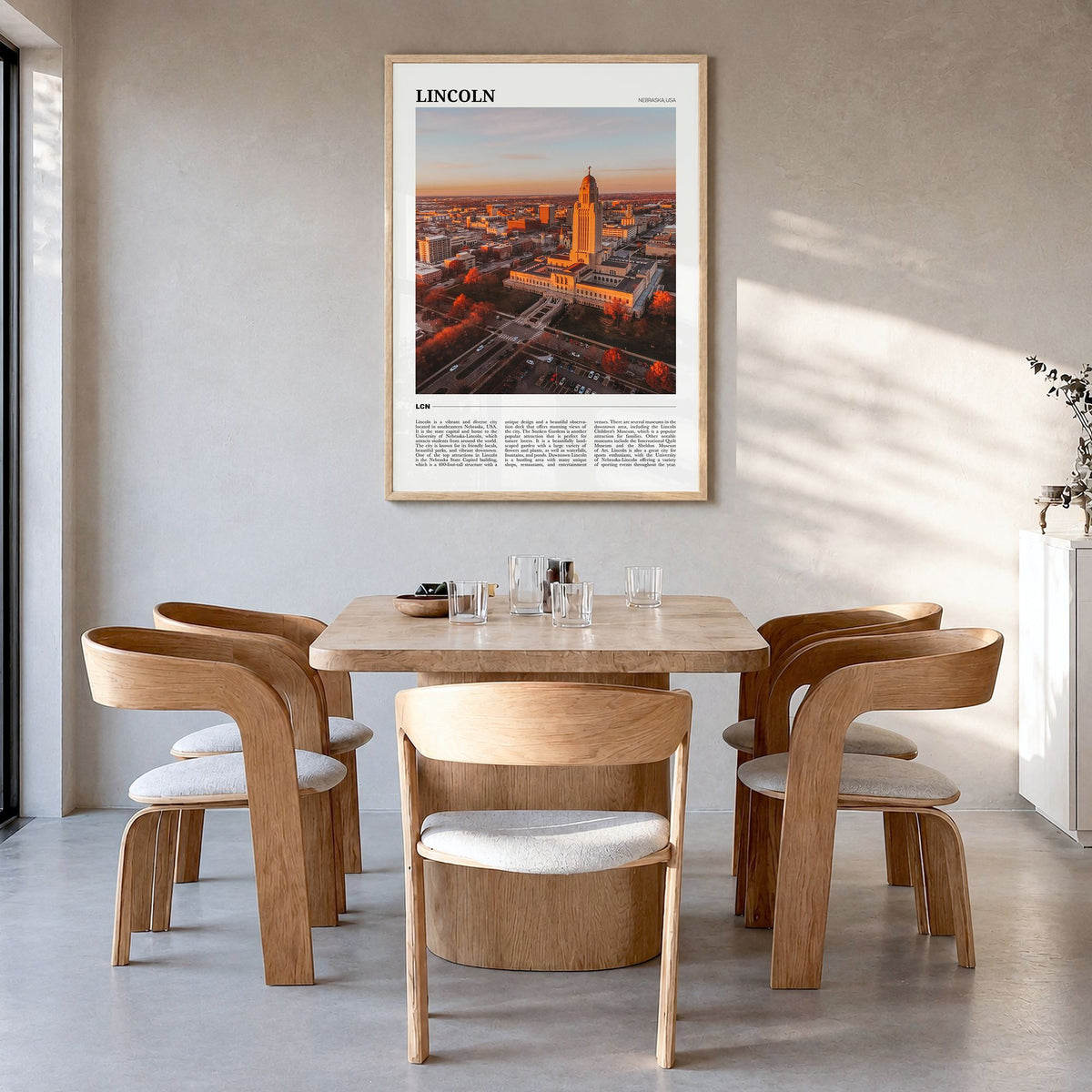 Lincoln Travel Poster in a natural wood frame, hanging in a dining room