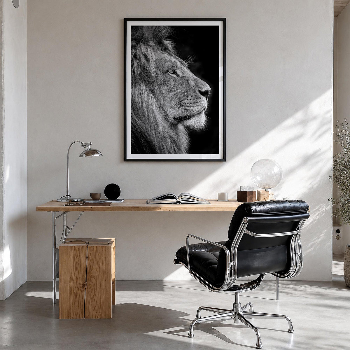 Lion no. 1 black & white photo poster – vertical wall art in black wood frame with white border, hanging on wall
