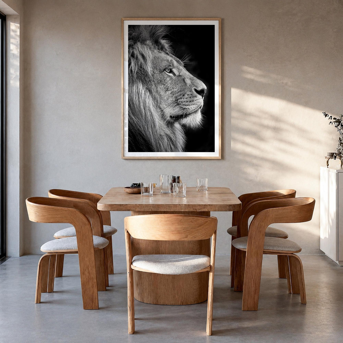 Lion no. 1 black & white photo poster – vertical wall art in natural wood frame with white border, hanging on wall