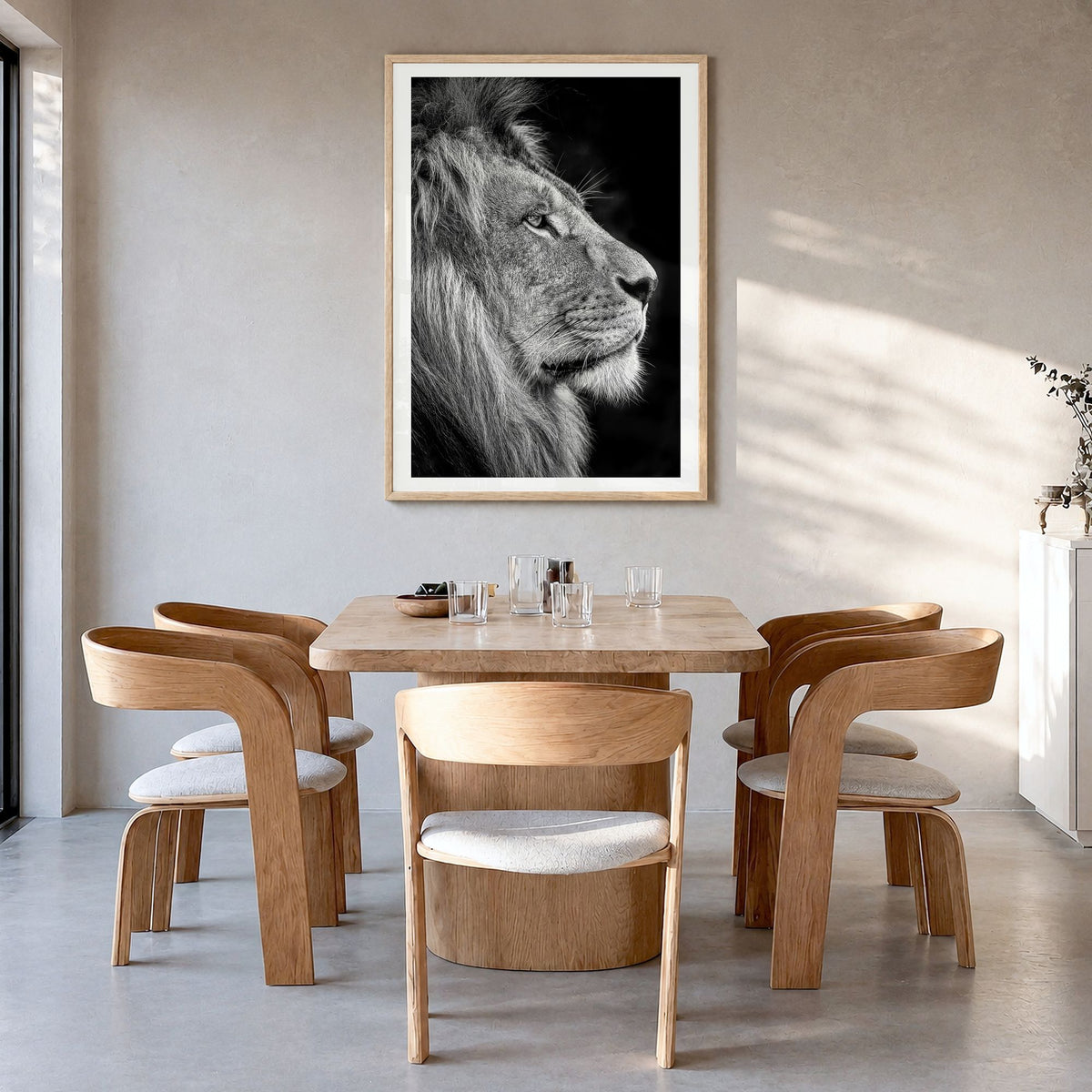 Lion Photo No 1 Poster in a natural wood frame, hanging in a dining room, white border