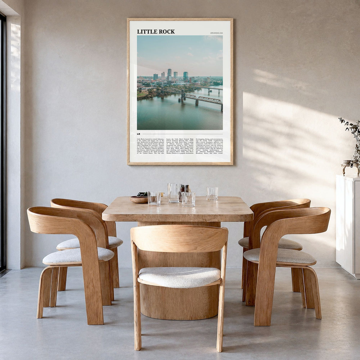 Little Rock Travel Poster in a natural wood frame, hanging in a dining room