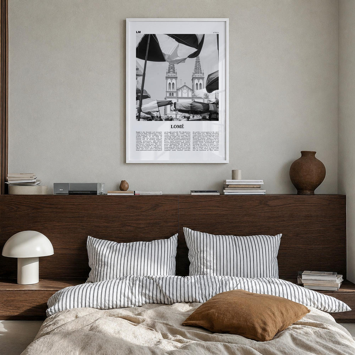 Lomé black & white newspaper poster of Togo – vertical wall art in white wood frame, hanging on wall