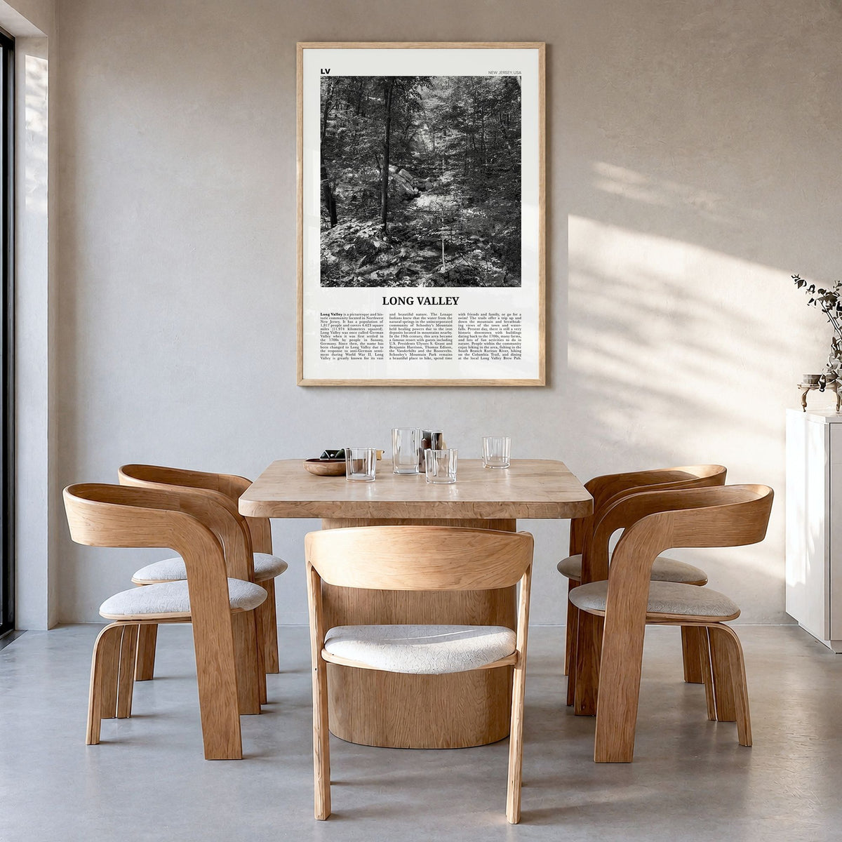 Long Valley Newspaper Poster in a natural wood frame, hanging in a dining room