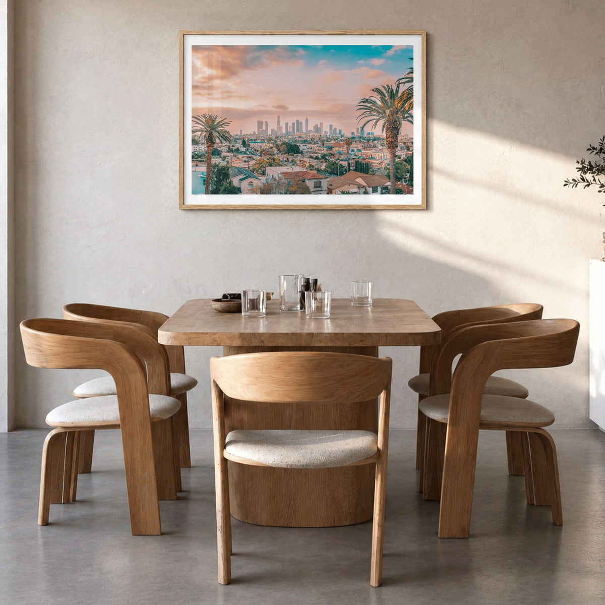 Los Angeles Photo Poster in a natural wood frame, hanging in a dining room, white border