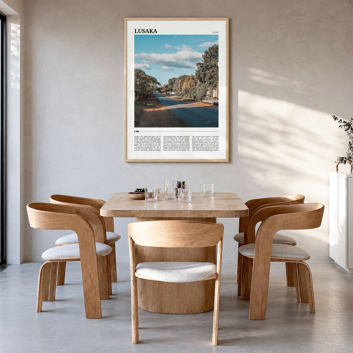 Lusaka Travel Poster in a natural wood frame, hanging in a dining room