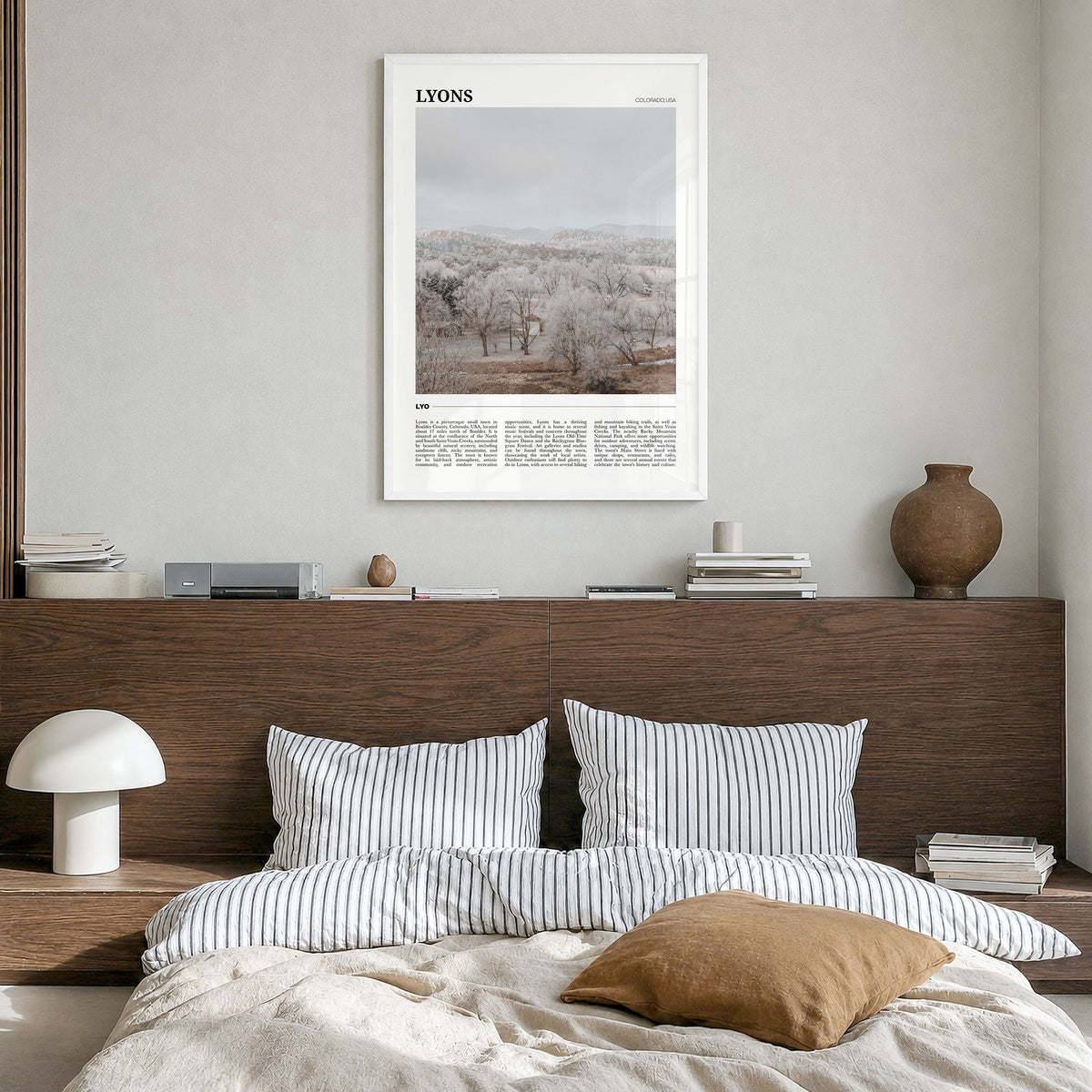 Lyons Travel Poster in a white wood frame, hanging in a bedroom