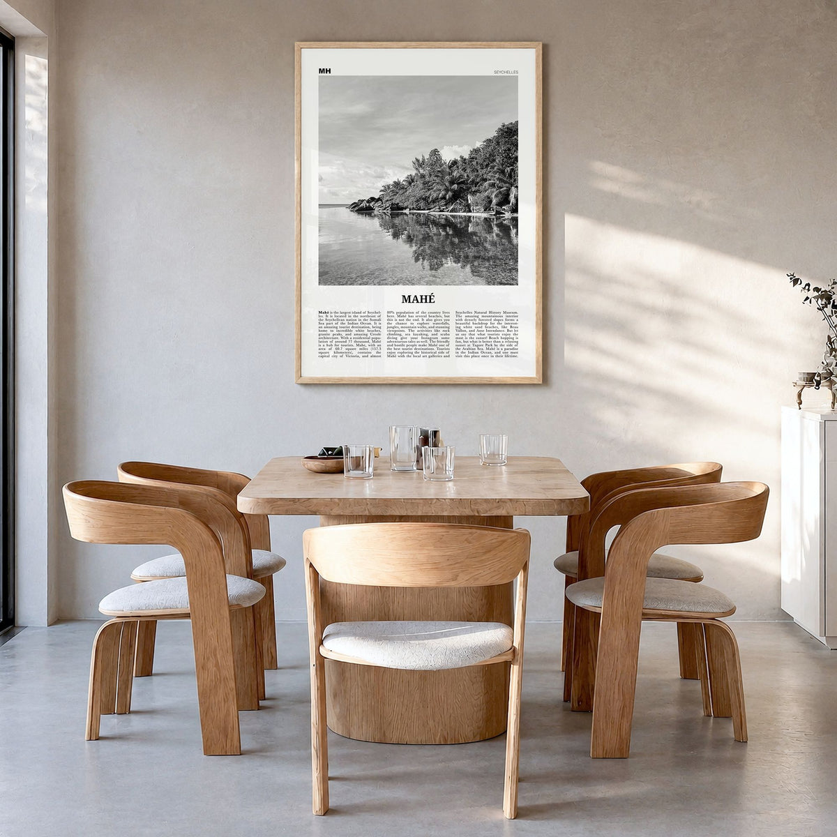 Mahé Newspaper Poster in a natural wood frame, hanging in a dining room