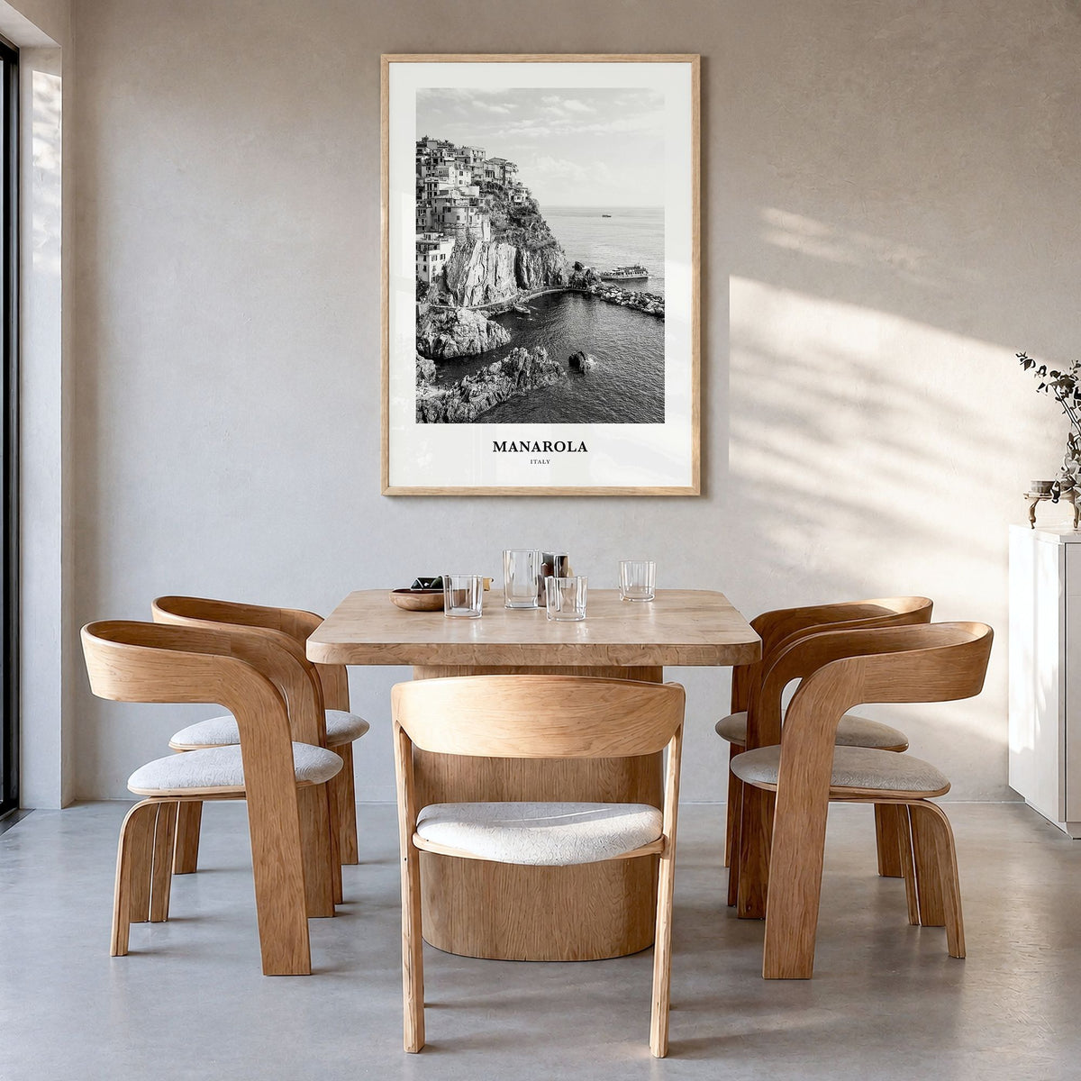 Manarola Classic Poster in a natural wood frame, hanging in a dining room