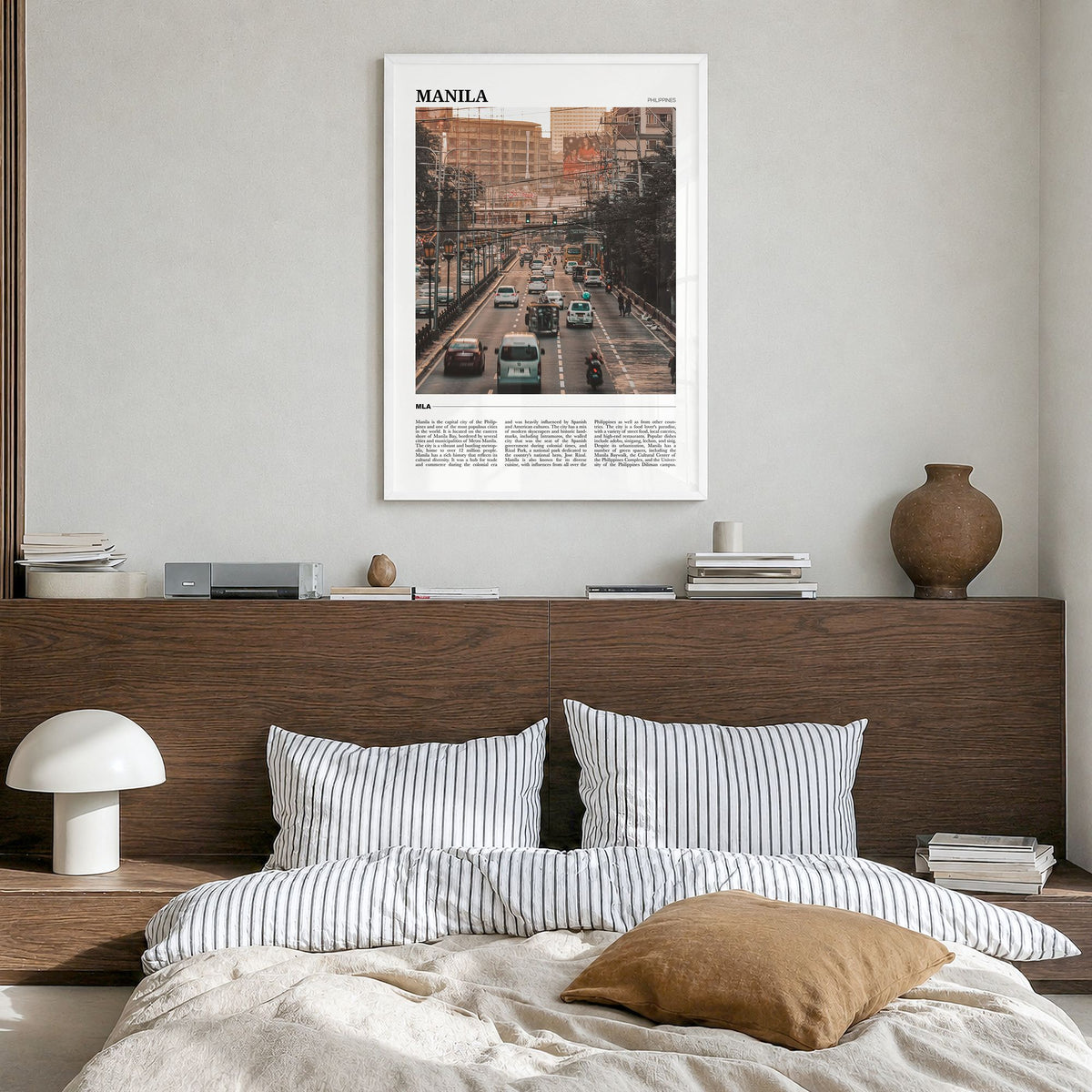 Manila Travel Poster in a white wood frame, hanging in a bedroom
