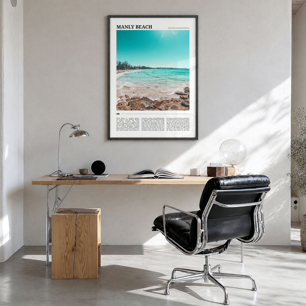 Manly Beach Travel Poster in a black wood frame, hanging in a bright home office