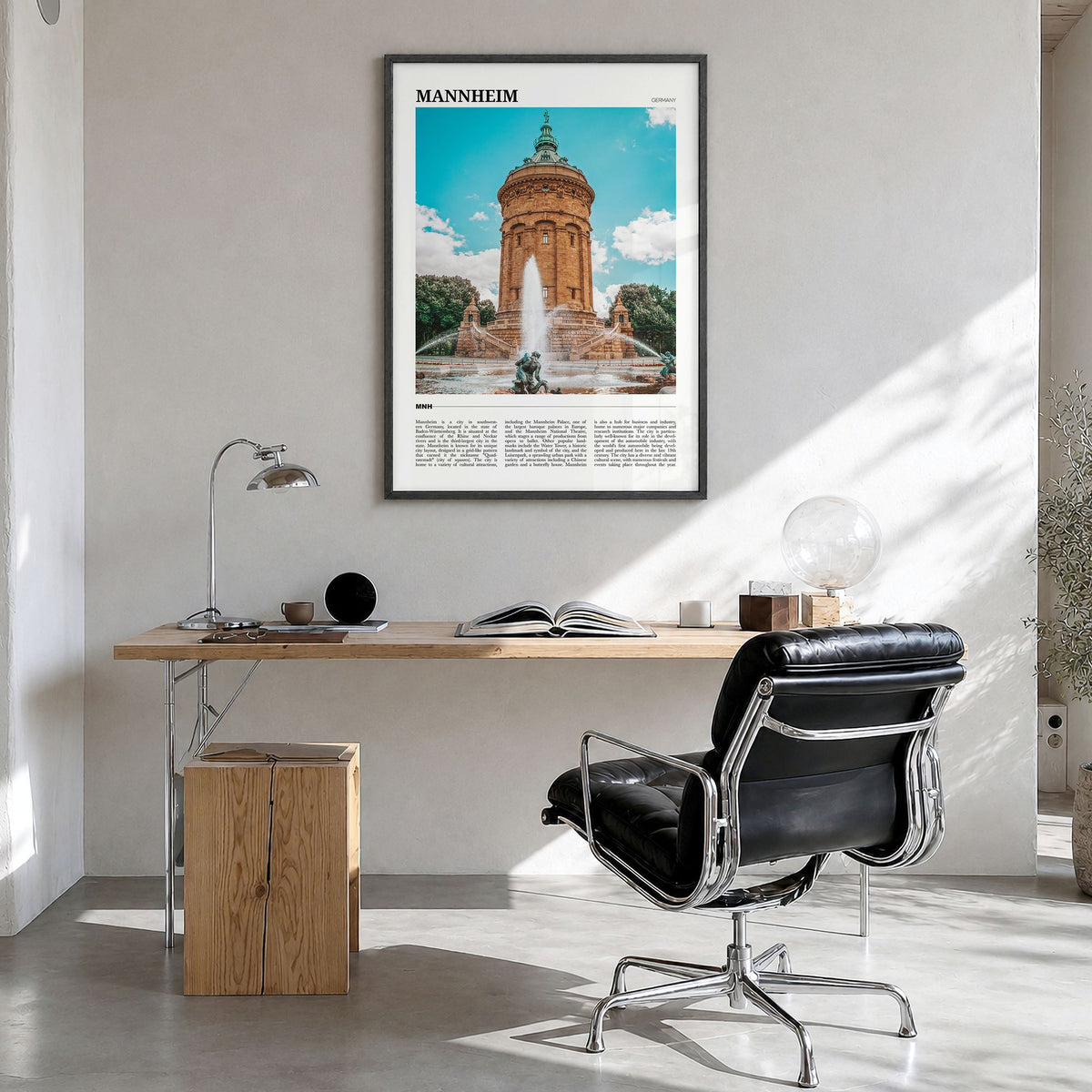 Mannheim Travel Poster in a black wood frame, hanging in a bright home office