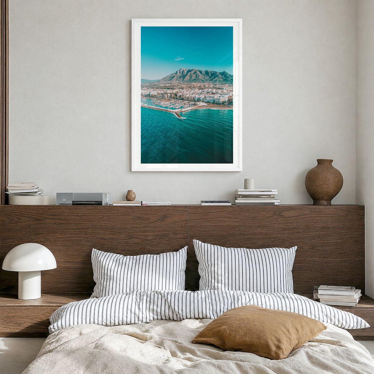 Marbella Photo Poster in a white wood frame, hanging in a bedroom, white border