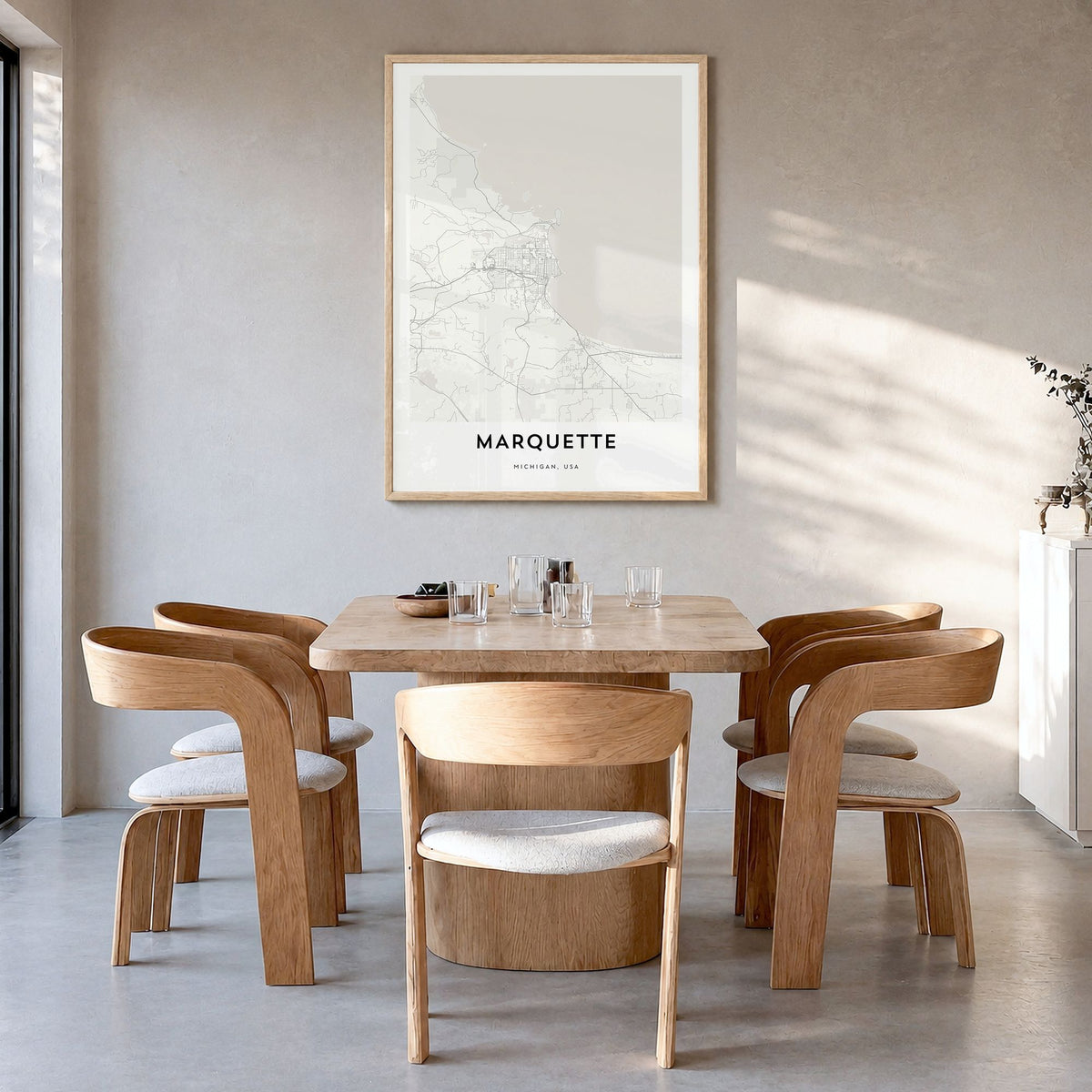 Marquette Map Poster in a natural wood frame, hanging in a dining room