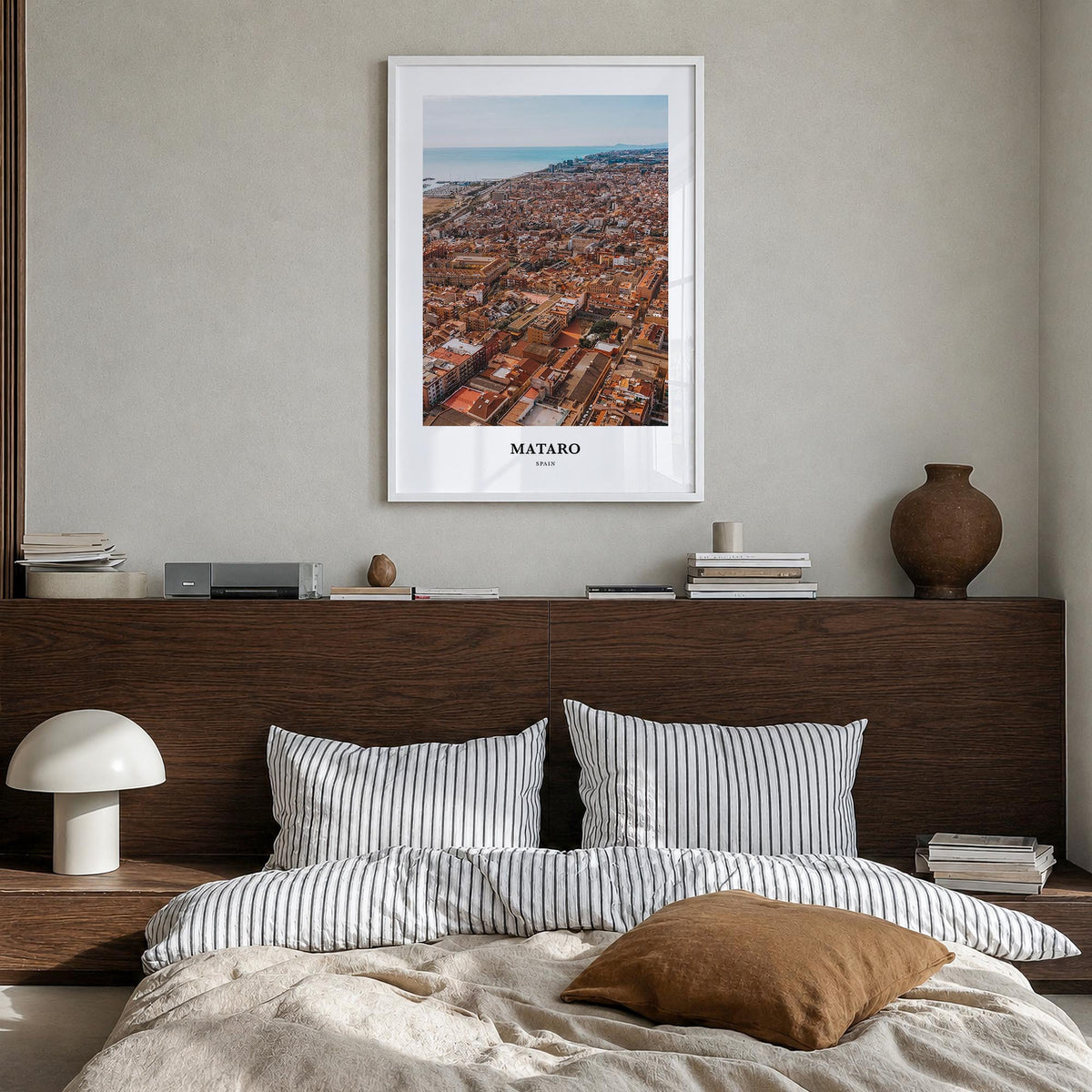 Mataró colorful classic poster of Spain – vertical wall art in white wood frame, hanging on wall
